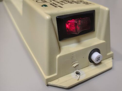 Illuminated power switch and 15-amp circuit breaker.