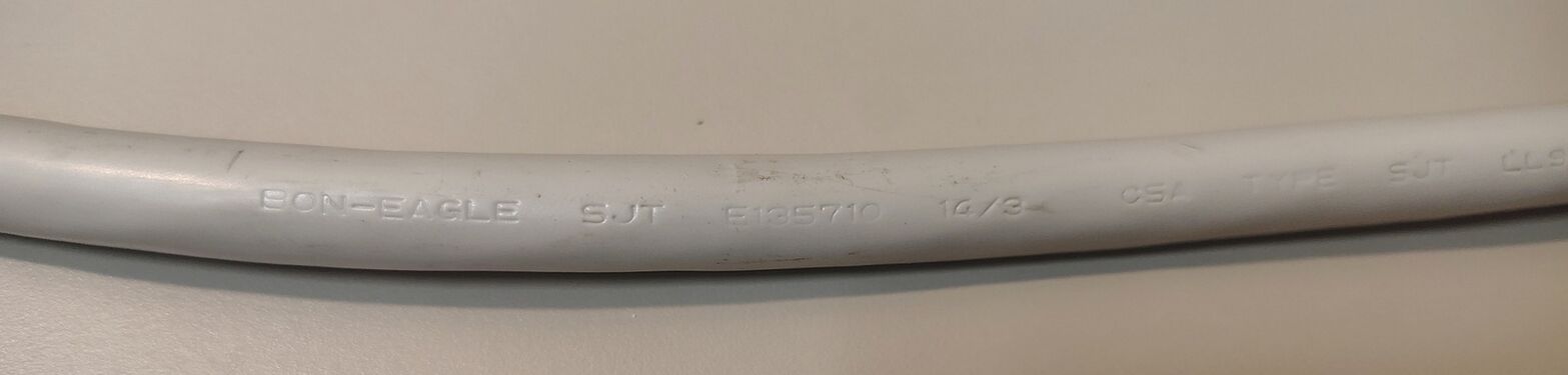 Power-cord markings showing manufacturer and construction information.