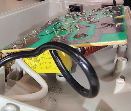 Underside view of the suppression circuit board showing solder joints, choke assembly, and filtering components.
