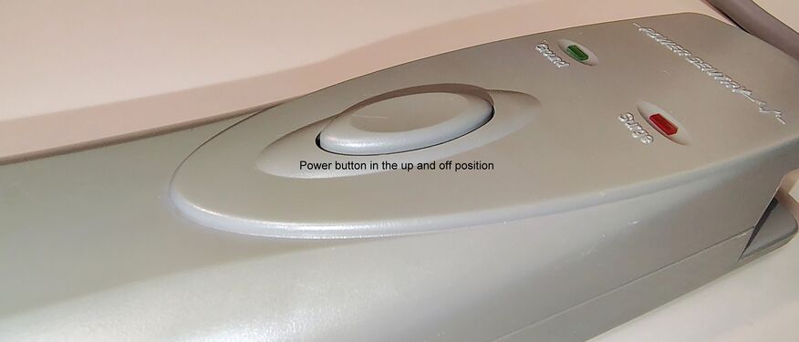 Push-button switch in the raised OFF position following release of power to the outlet bank.
