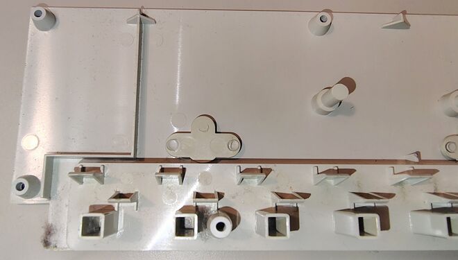 Interior of the upper enclosure showing molded outlet supports and enclosure construction.
