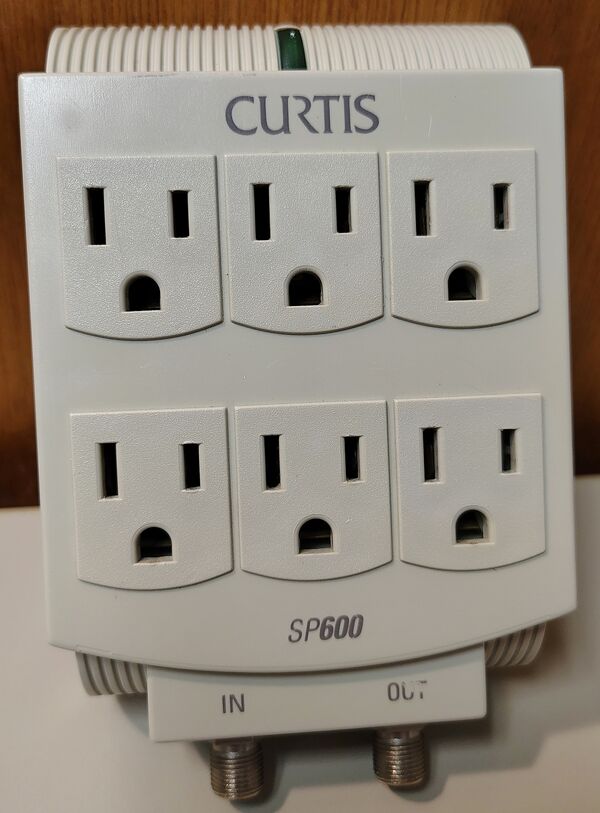 Curtis SP-600 wall-mounted surge protector documented by the OldSurge Archive.