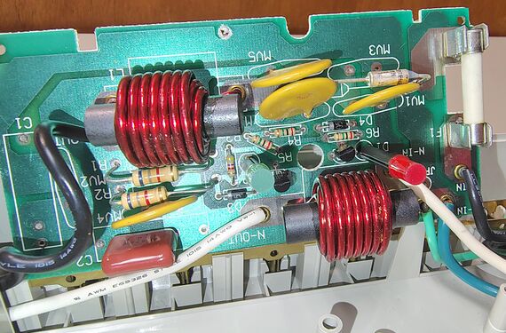 Component side of suppression board showing inductors, MOVs, fuse, and filtering circuitry.