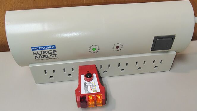 Receptacle tester indicating correct wiring and grounding.