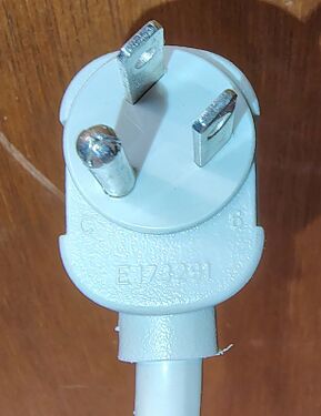 Right-angle attachment plug showing grounding pin, plug construction, and approval markings.