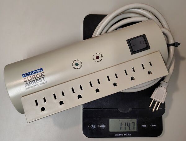 Documented APC SurgeArrest Professional PRO7 weighing approximately 1 pound 14.7 ounces (842 grams).