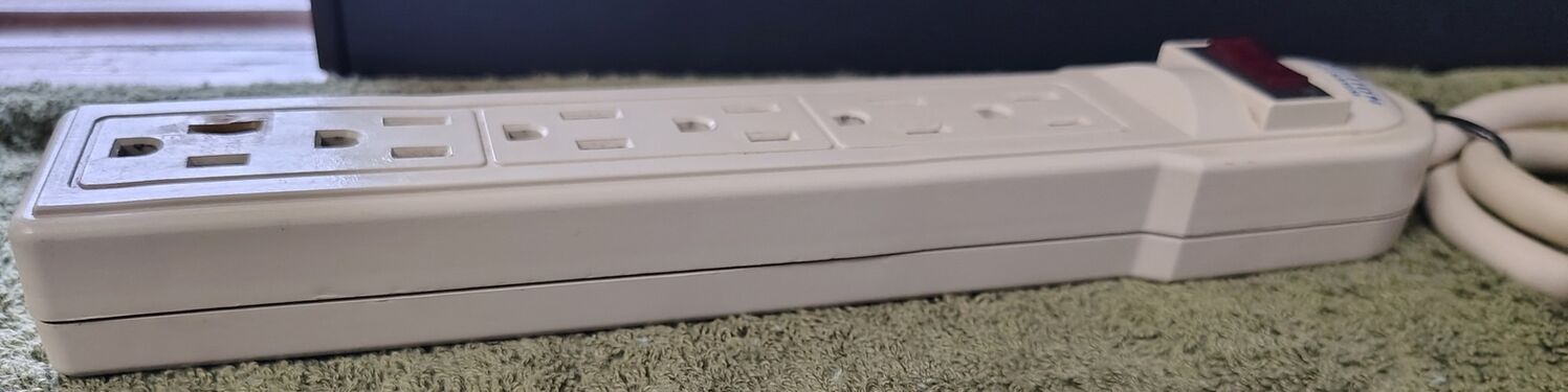 Right-side profile view with visible outlet damage.