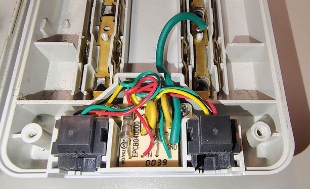 Rear view of the telephone line protection board showing the EPCB04000 fuse and surge protection components.