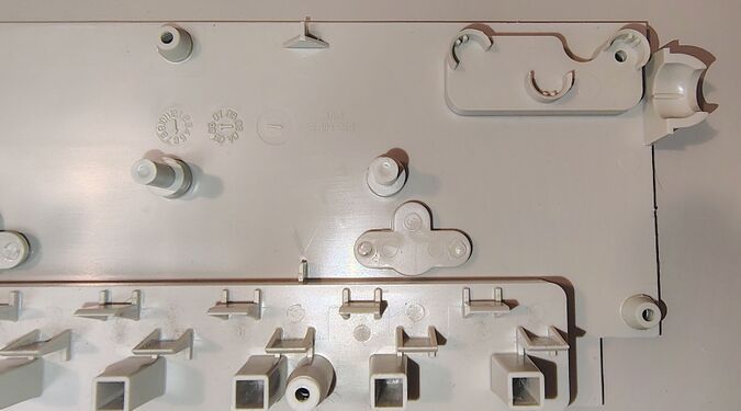 Upper-housing cord-entry area showing molded support structures, cord-retention features, and internal date-code wheels.
