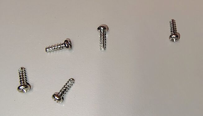 Five of six enclosure screws removed during disassembly.