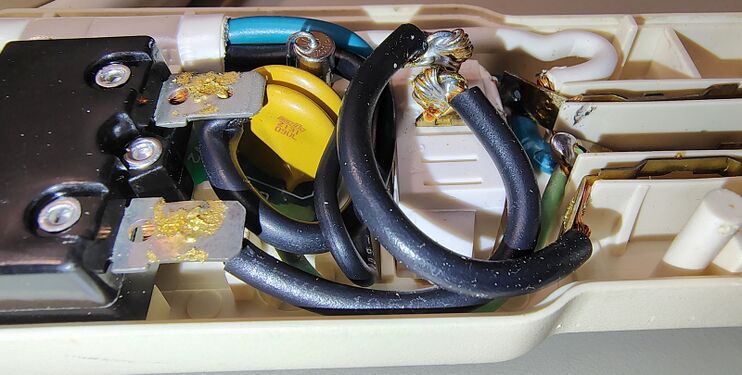 Close-up of the surge-suppression circuit board, circuit breaker terminals, and power-cord wiring.