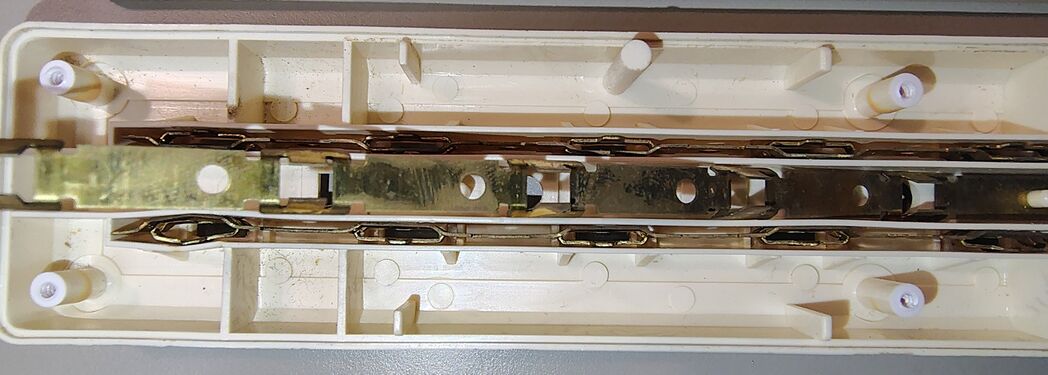Lower housing showing outlet contacts, bus bars, wiring, and suppression circuitry.