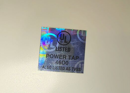 UL hologram label identifying the device as a listed Power Tap and TVSS.