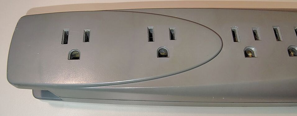 Transformer-spaced outlet section showing the widened outlet geometry intended for oversized power adapters.