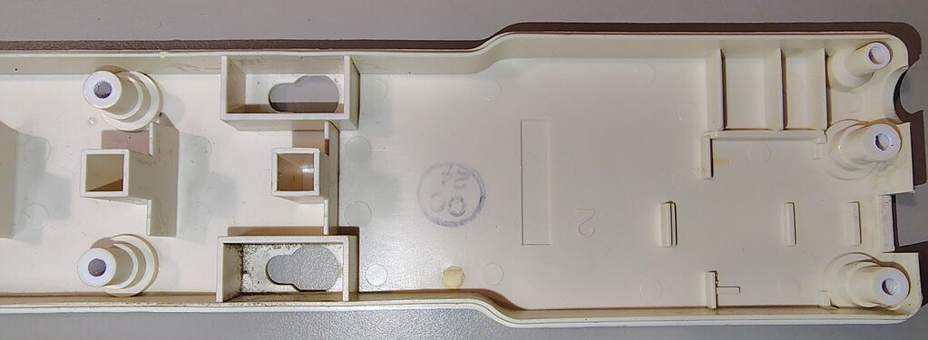 Switch-end interior of the upper housing showing mounting features for the rocker switch and circuit breaker.