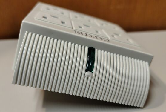 Top edge showing ribbed side structure and green protection-status indicator.
